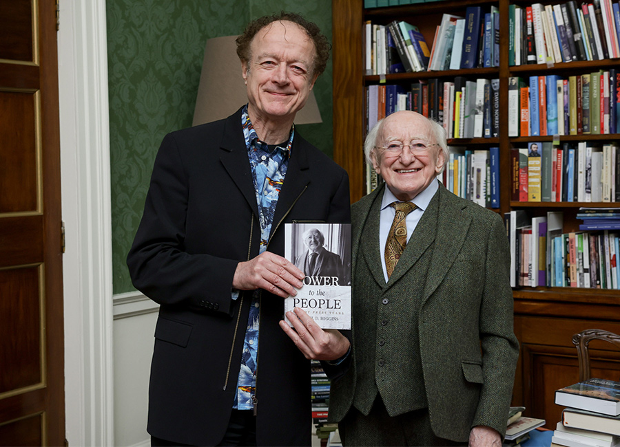 Hot Press editor Niall Stokes presents President Michael D. Higgins with a copy of the new book Power To The People (The Hot Press Years). Pic: Maxwell's